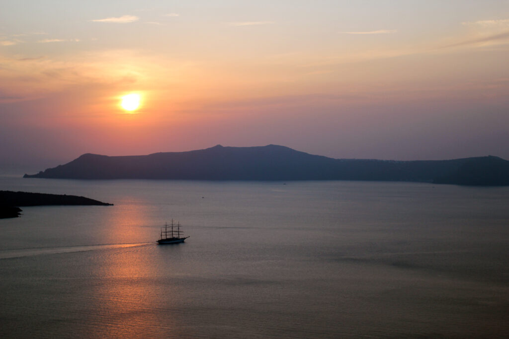 Ship Near Santorini Volcano at Sunset