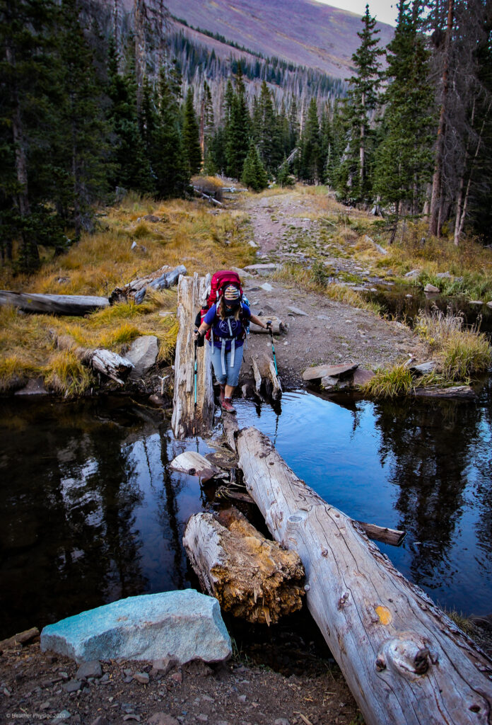 Lori Crossing Water on Log at Humboldt Peak, Colorado