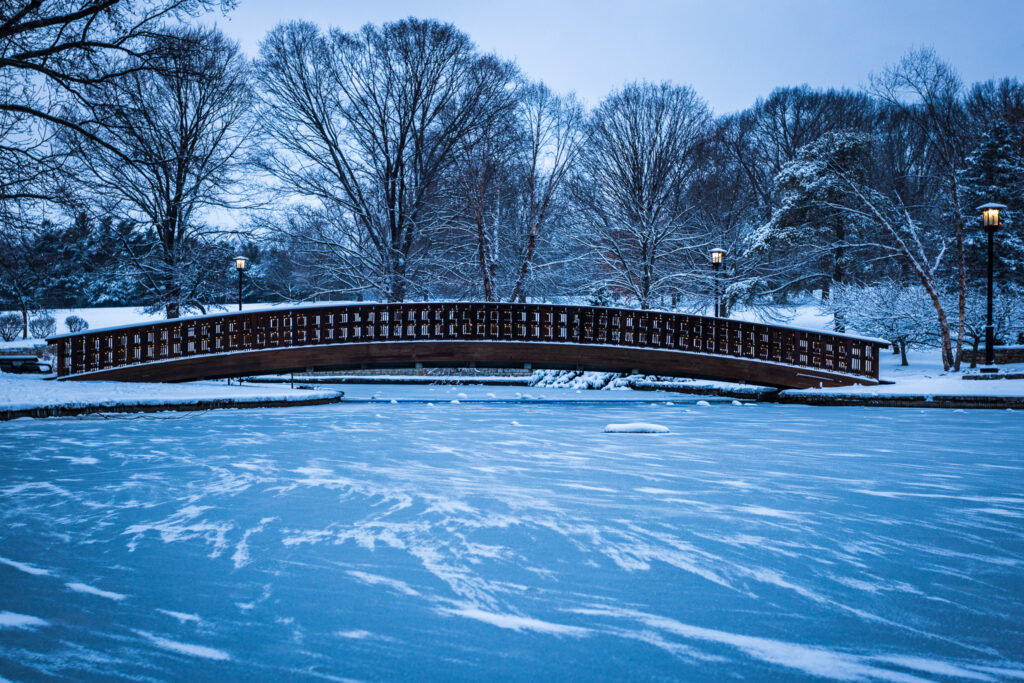 Snow Glides on Frozen Pond, Bridge at Loose Park in Kansas City, MO