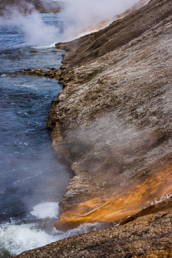 Steaming Hot Springs Chuting into the River at Yellowstone National Park