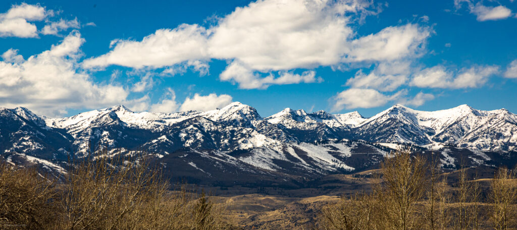 Snowy Gallatin Mountain Range behind golden Paradise Valley on a sunny day in Montana