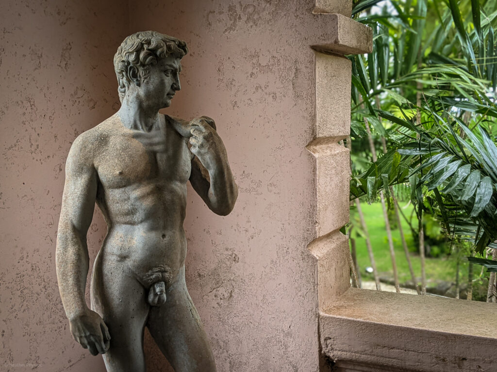Statue of David eyeing palm trees outside an arched window at Clifton Hall Great House in Barbados - photo by Heather Physioc