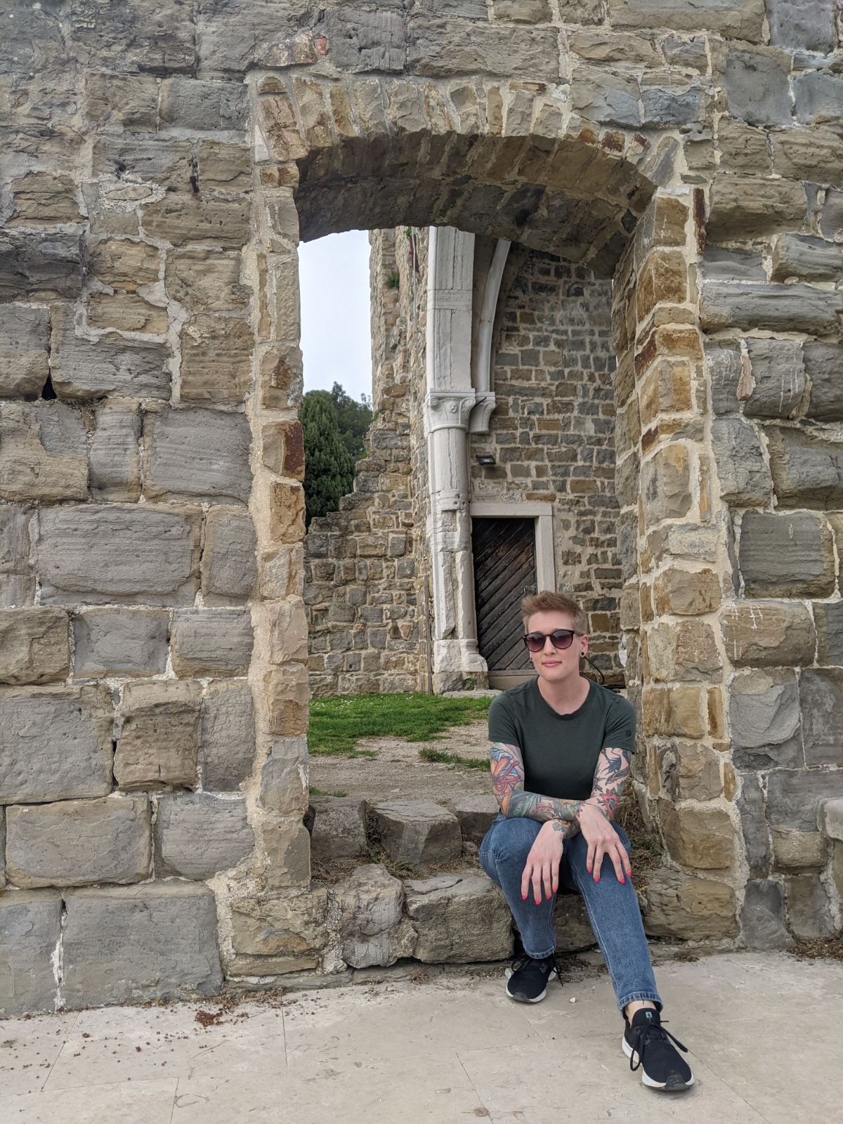 Heather Physioc sitting on the steps of a stone cathedral in Portorož, Slovenia